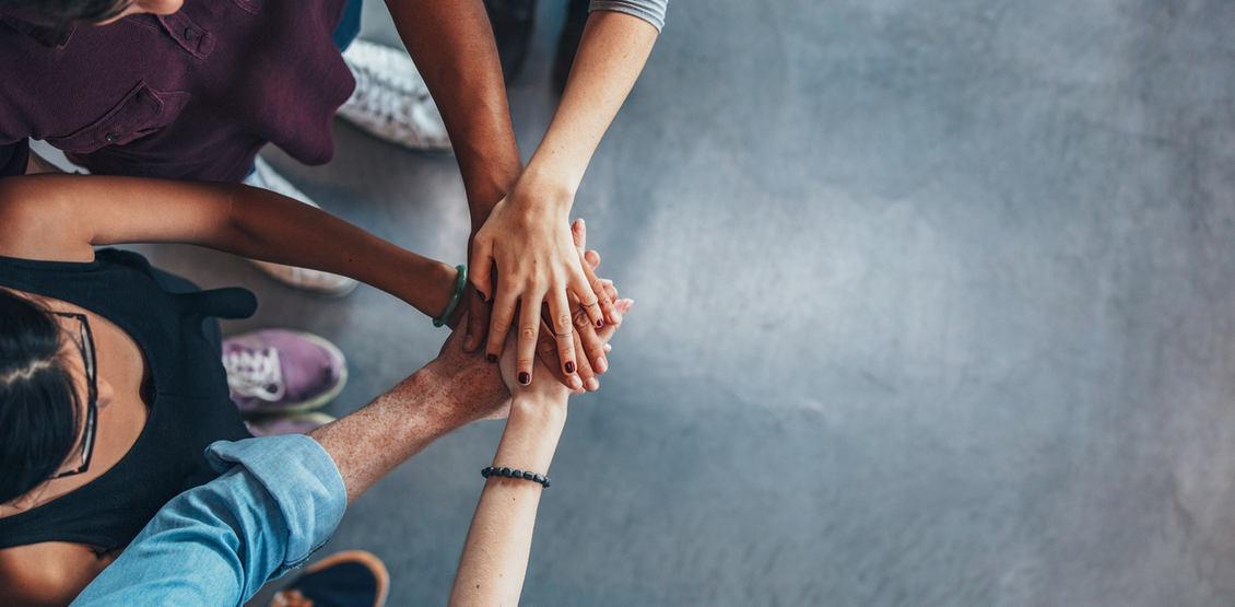 Group Of young people stacking their hands