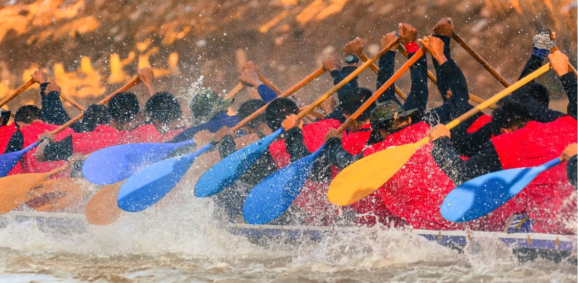 Crew rowing in a river