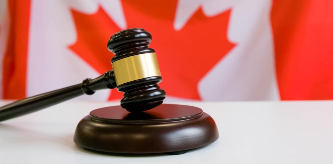 Photo of a judge's gavel in front of a Canadian