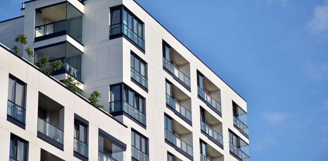 modern-apartment-buildings-on-a-sunny-day-with-a-blue-sky-picture-id1177797403