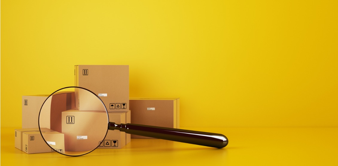 pile-of-cardboard-boxes-on-the-floor-on-a-yellow-background-with-a-picture-id1275996754